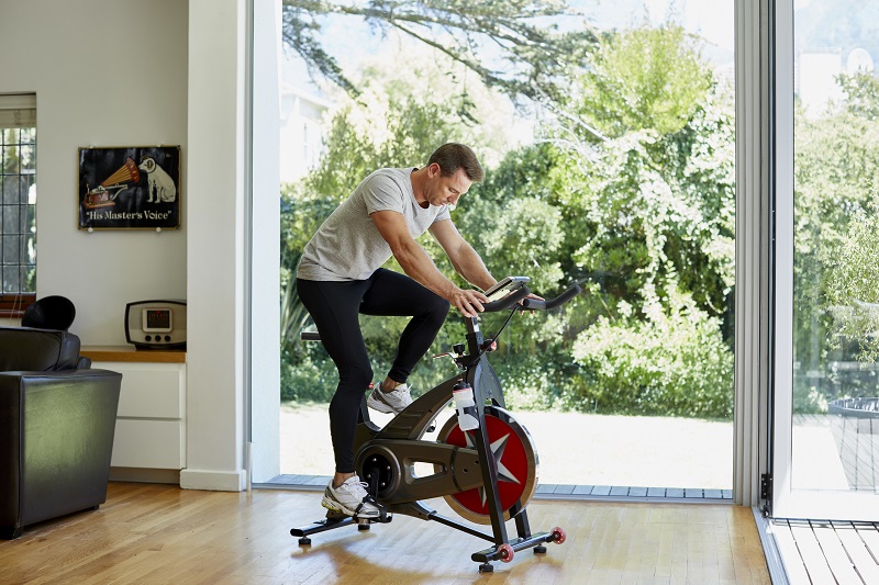man exercising on a stationary bike indoors
