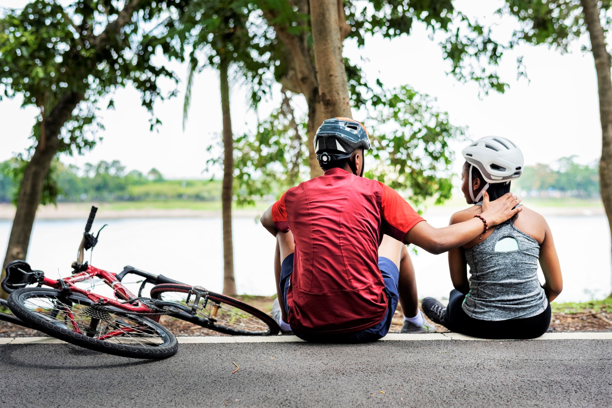 couple resting in a park after cycling