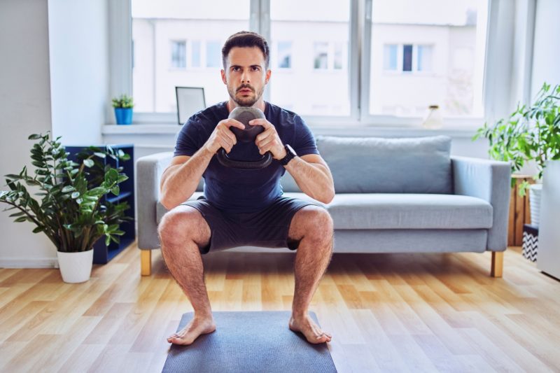man doing full-body workout at home