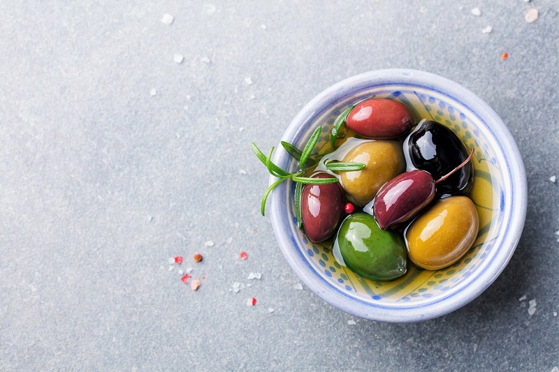 a variety of olives in a small ramekin. healthy snack ideas