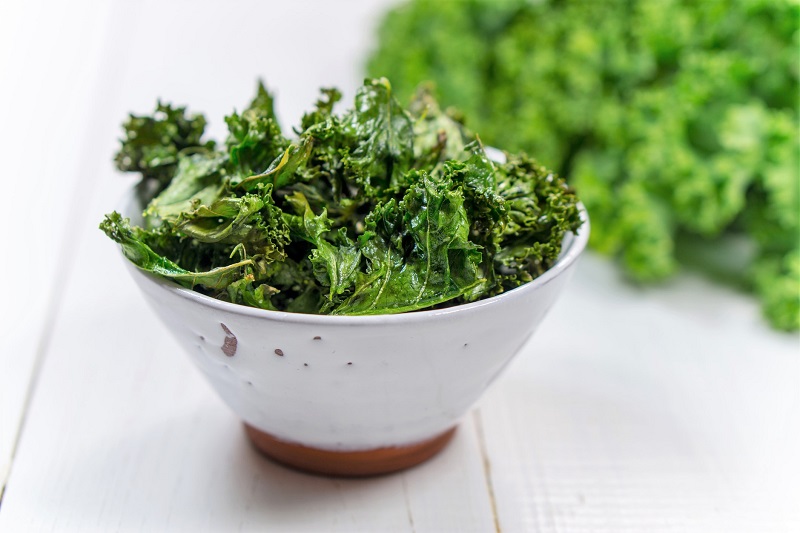 oven baked kale chips in a bowl. healthy snack ideas