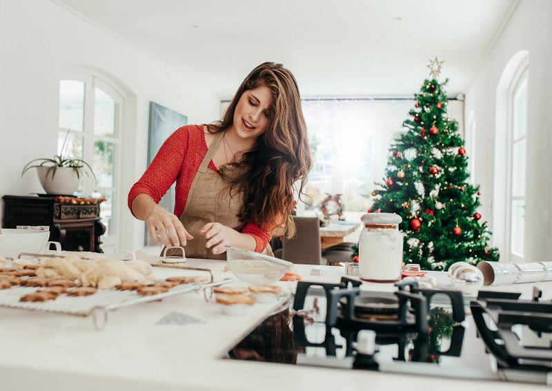 A woman prepping christmas cookies for baking. winter weight loss tips