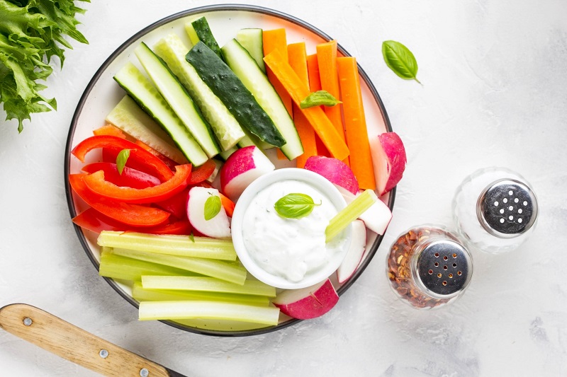 veggies and dip, with carrots, red peppers, cucumbers, and celery
