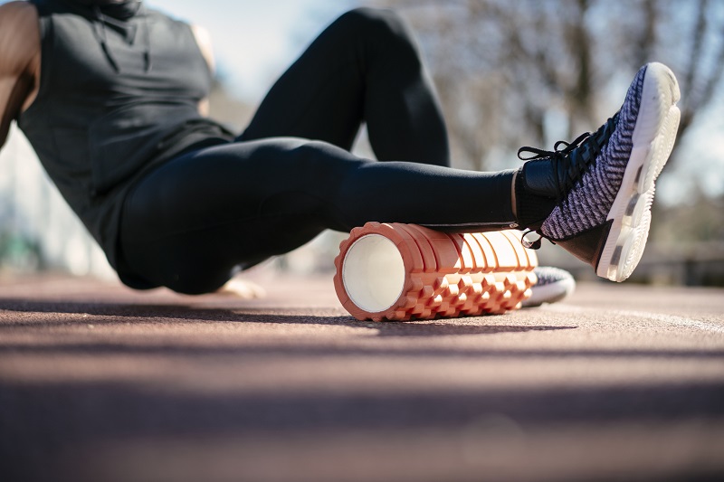 a man using a foam roller outside. holiday gift ideas