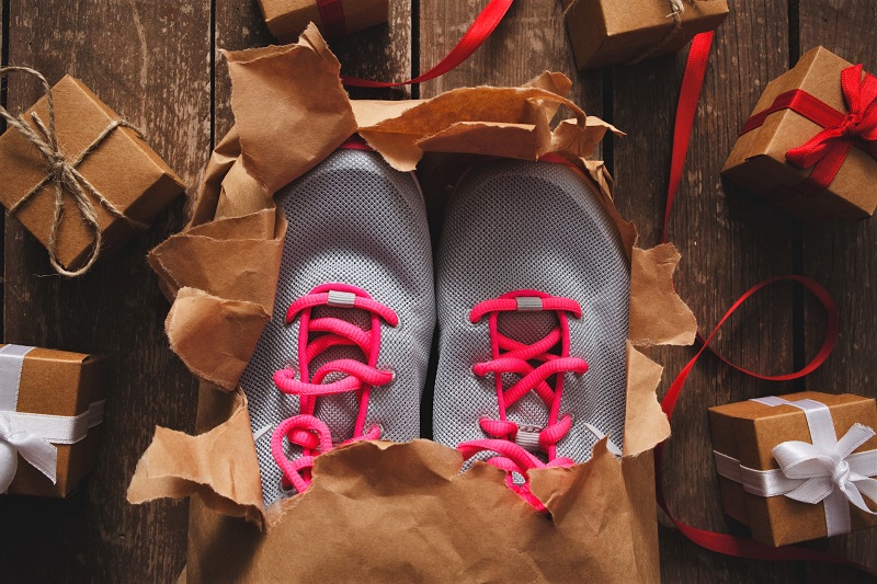 unboxed holiday gift of gray and pink running sneakers. holiday gift ideas