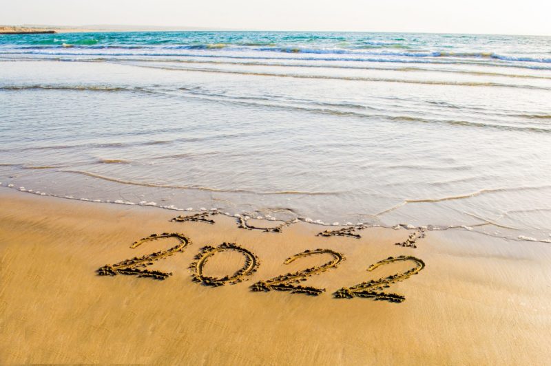 happy new year 2022 text on the sea beach.