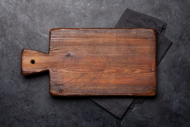 a dark wooden cutting board for charcuterie