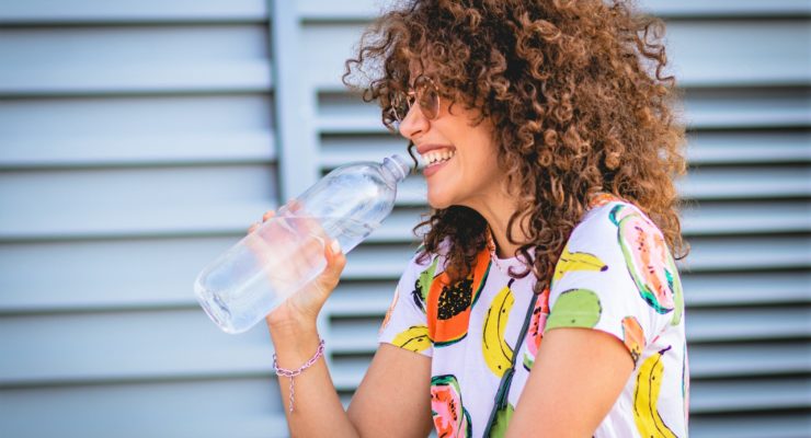 woman drinking water to get back on track