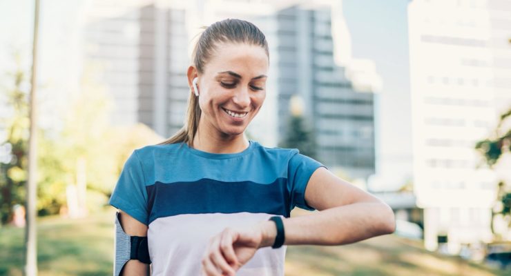 woman checking fitness tracker step goals