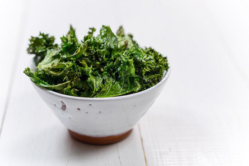 fresh kale in a large white bowl