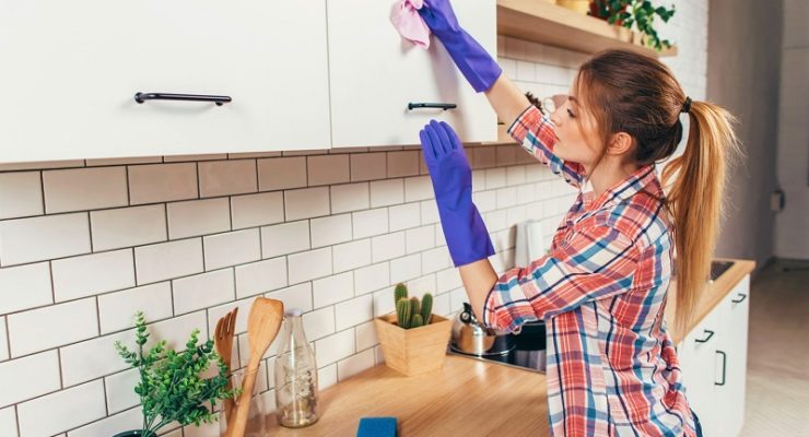 woman cleaning the furniture in the kitchen.