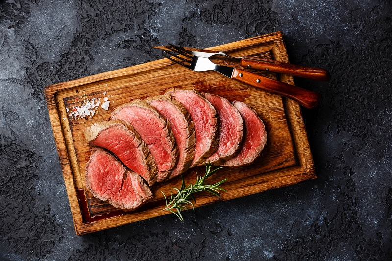a freshly prepared steak with thyme as garnish 